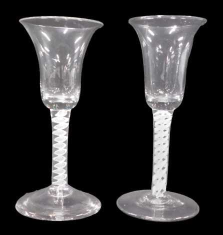 Two 18thC wine glasses, with bell shaped bowls and double opaque twist stems, on plain feet, 16.2cm and 16.5cm high.