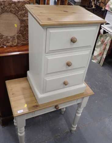 A pine side table, the top with moulded edge, the painted base with a frieze drawer, on turned legs, 75cm high, 75cm wide, 42cm deep, together with a matching three drawer chest, 68cm high, 46cm wide, 35cm deep.