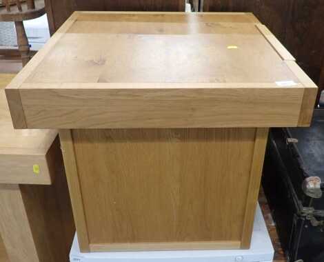 A John Lewis oak coffee table, the square top with a frieze drawer, on block end supports, 51cm high, the top 60cm x 60cm.