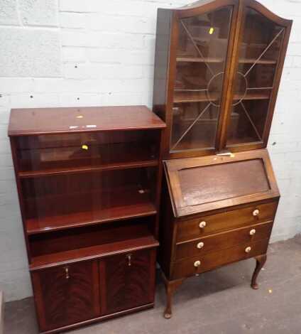 An oak bureau bookcase, in the Art Deco style, the top with astragal glazed doors and arched top, above fall flap and three drawers, on pad feet, and a reproduction bookcase. (2)