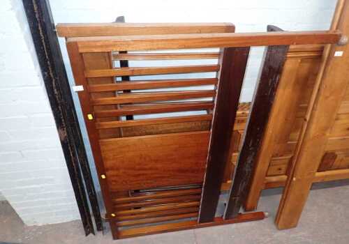 A 20thC mahogany double bed frame, with a slatted back, comprising headboard, foot, and iron side rails.