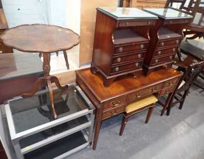 A group of furniture, to include a mahogany and crossbanded desk, with an arrangement of five drawers on square legs, 76cm high, 117cm wide, 54cm deep, two mahogany bedside chests, a tripod table, etc. (a quantity)