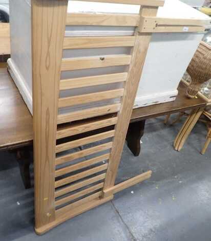 A pine double headboard, with a slatted back.