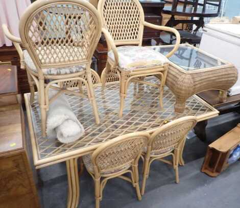 A caned conservatory suite, comprising glass top dining table, six chairs, including two carvers, and a wicker coffee table, with inset glass panel.