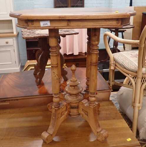 A hardwood occasional table, with a shaped top, on four turned supports, united by a turned finial, on scrolling legs, 66cm high.