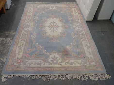 A Chinese cream ground wool rug, porters to measure