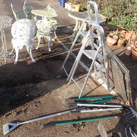 Two A frame step ladders, together with various garden tools.