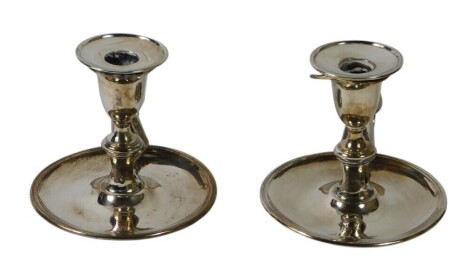 A pair of early 19thC Sheffield plate chamber sticks, each with snuffers and engraved with a stag crest, 13.5cm wide high. Upon initial inspection general wear to both, one candlestick has wear to bottom rim or edge, crest, thumbpiece and sconce, the othe