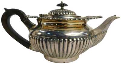 An Edward VII silver teapot, of semi fluted form, with ebonised knop and handle, J&J Maxfield Ltd, Sheffield 1904, 23.73oz gross.