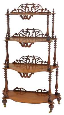 A Victorian mahogany four-tier waterfall whatnot, each shaped shelf with a raised pierced back, united by turned columns, on ceramic castors, 140cm high, 69cm wide, 32cm deep.