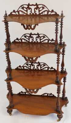 A Victorian mahogany four-tier waterfall whatnot, each shaped shelf with a raised pierced back, united by turned columns, on ceramic castors, 140cm high, 69cm wide, 32cm deep. - 2