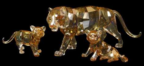 A Swarovski crystal Endangered Wildlife 2010 Edition tiger, 9cm high, together with two cubs, 5cm and 4.5cm high, the tiger with certificate of authenticity, each boxed. Upon initial inspection no apparent damage.