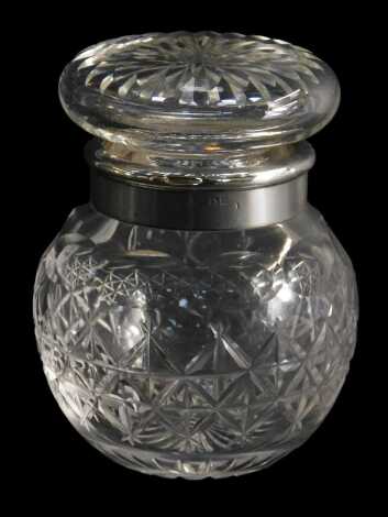 A George V cut glass dressing table jar and stopper, with silver collar, London 1919, 11cm high.