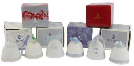 Six Lladro bisque porcelain Christmas bells, each of differing design dated 2004, 1994, 2001, 1992, 2006 and 1990, boxed.