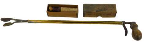 A brass equine pill administrator, with cast iron tongs and a turned wooden handle, together with a bottle of Harvey's Embrocation.