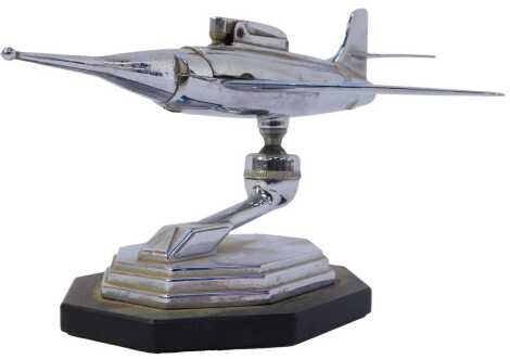 Aviation interest. A 1950s chrome table lighter, modelled in the form of a fighter jet, on a Bakelite base, 12cm high.