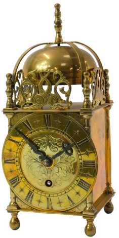 An Empire brass lantern clock, the circular chapter ring bearing Roman numerals, with a thirty hour movement, the case of typical form, stamped to movement Empire Made in England, 25cm high.