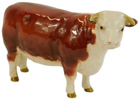 A Beswick pottery figure, modelled as CH of Champions Cow, printed marks, 10cm high.