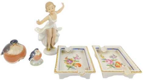 A group of ceramics, comprising a Royal Copenhagen porcelain robin, 6cm high, and a further bird, two Dresden porcelain ashtrays, each decorated with flowers, gilt heightened, printed marks, 11cm wide, and a Wallendorf porcelain figure modelled as a girl 