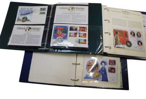 Two The Royal Family Coin First Day albums, and another, containing coins and stamps of the world to include the Portugal Olympic Games 1992 Christopher Columbus, etc.