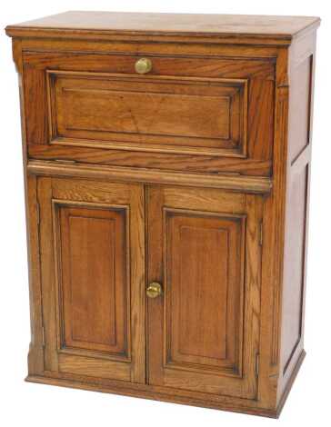 A 20thC oak radiogram cabinet, the rectangular moulded top above a panelled fall, with two panelled doors to the base enclosing two shelves, 95cm high, 70cm wide, 39cm deep.