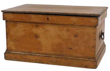 A Victorian stripped pine chest, the panelled top with a carved border enclosing a vacant interior with two metal handles to each side, on a plinth base, 41cm high, 77cm wide, 50cm deep.