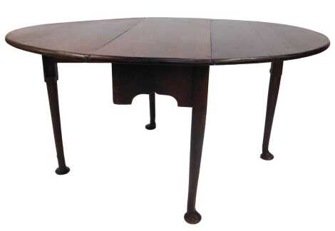 A Georgian oak drop leaf table, raised on cylindrical tapering legs with pad feet, 67cm high, 103cm wide, 38cm deep, 140cm extended.