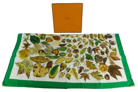 A Hermes silk scarf, decorated with autumnal leaves within a green border, 87cm x 87cm, boxed.