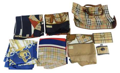 A group of Burberrys silk scarves, together with an unnamed silk scarf titled Cliquetis, decorated with military-related emblems, a Burberrys hip flask, wallet and a folding tote bag.