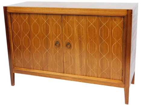 A 1950s Gordon Russell of Broadway mahogany and rosewood Helix sideboard, the two doors opening to reveal a shelf, short drawer and two recesses, raised on square legs, 84cm x 122cm x 46cm.