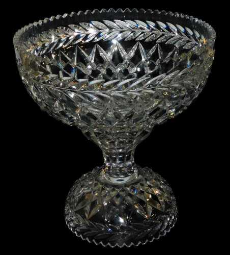 A cut glass pedestal bowl, engraved with a band of leaves, the circular bowl, raised on a detachable stand, 39cm high.