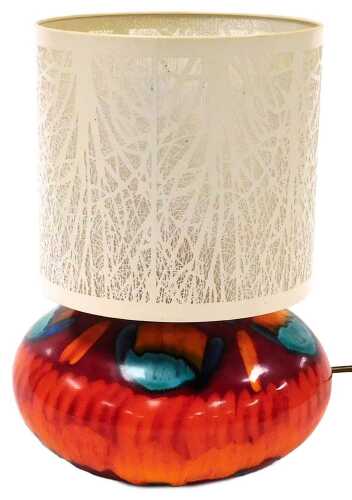 A Poole Pottery Volcano pattern table lamp, with a pierced cream metal shade, 32cm high.