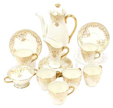 A Royal Doulton porcelain part coffee service, gilt decorated with flowers, scrolling leaves and rococo scrolls, printed marks, comprising coffee pot, cream jug, twin handled sugar bowl, six coffee cups and saucers.