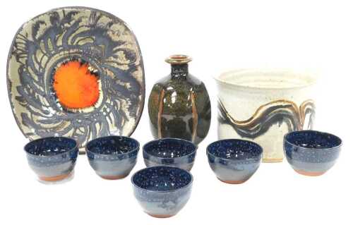 A group of studio pottery, including a Chelsea pottery dish, 26.5cm wide, six Skyeramics blue glaze bowls, Muchelney pottery vase, designed by John Leech, and pottery bowl with brown and black oxide wave decoration, incised indistinct signature to base, 1