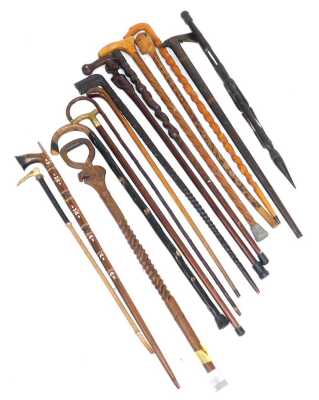 A group of African carved walking sticks, with figural terminals, further sticks, and a riding crop. - 2