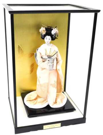 A Japanese The Madam Butterfly Wedding doll, designed by Hannae Mori, with stand, cased with title plate, case 58cm high.