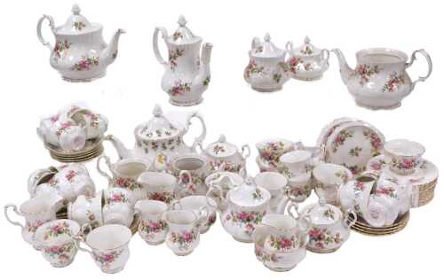 A Royal Albert porcelain Moss Rose pattern tea and coffee service, including graduated teapots, coffee pot, sucrier, sugar bowls, cream and milk jugs, tea and coffee cups, saucers, plates, bread plates, teapot stands, etc. (a quantity)