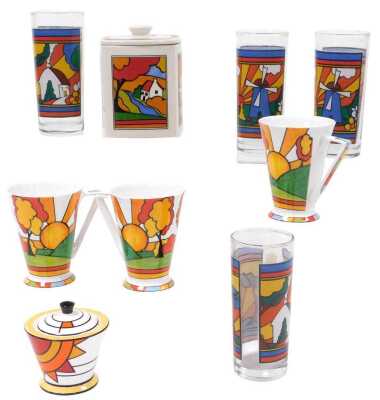 A Brian Wood Collection porcelain Art Deco style sugar bowl and cover, Past Times Morning Sun pattern storage jar and cover, three coffee mugs, and four water glasses, printed with a windmill and cottage pattern. (9)