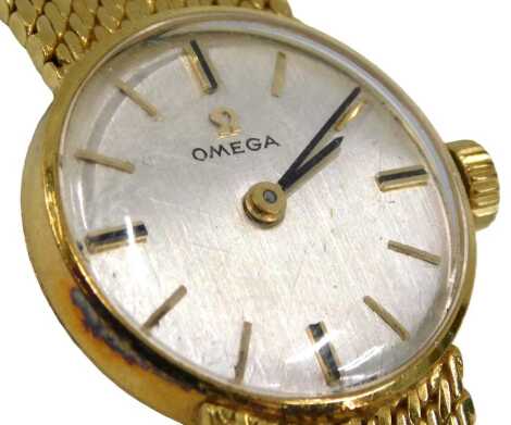 An Omega ladies gold wristwatch, the silver coloured dial with battons stamped Swiss Made, with 18ct gold strap, 38.5g all in, in red fitted Omega box.