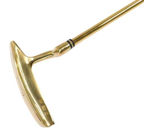 A gold golf putter, with solid 18ct gold head, ferrule or collar and ball marker, with a gold plated shaft, and a Cabretta leather handle, purchased from Harrods department store London for £6000, sold in original presentation case, the golf club 90cm lon