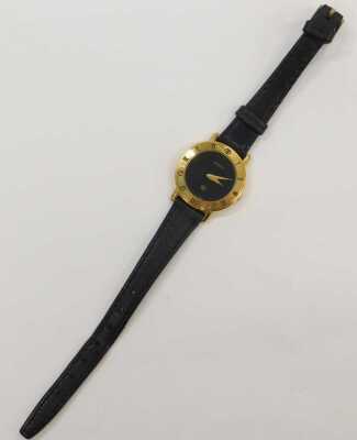 A Gucci lady's gold plated wristwatch, circular black dial, chapter ring bearing Roman numerals, serial number 3001 L, 201-220, on a leather strap, cased. - 2