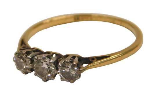 A diamond three stone ring, claw set, in yellow metal, stamped 18ct, approx 0.5ct, size O, 2.0g.