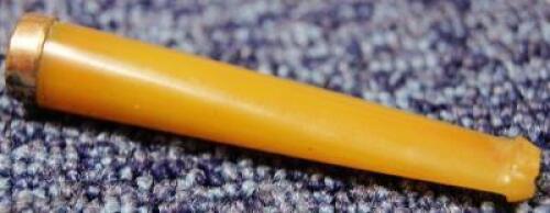 An amber coloured cigarette holder