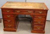 A late Victorian walnut kneehole desk by Maple & Co