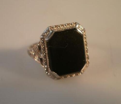 A black stone set dress ring