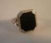 A black stone set dress ring