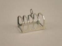 A small silver four division toast rack