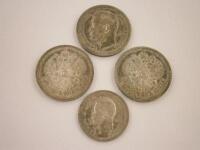 Three Russian silver fifty Kopek coins and a twenty five Kopek.