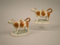 Two similar Staffordshire cow creamers and lids