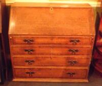 An early 19thC oak and mahogany cross banded bureau